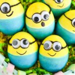 the picture has eggs decorated in yellow ,black ,white and blue