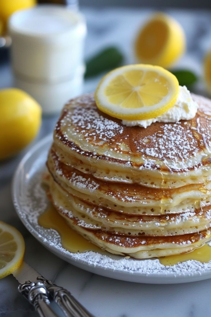 this picture contains a Fluffy Lemon Ricotta Pancakes Recipe